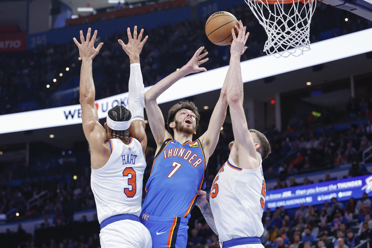 Dec 27, 2023; Oklahoma City, Oklahoma, USA; Oklahoma City Thunder forward Chet Holmgren (7) shoots between New York Knicks guard Josh Hart (3) and center Isaiah Hartenstein (55) during the second half at Paycom Center. 